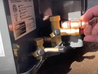 Brass manifold and valve assembly on a hydronic heat pump system